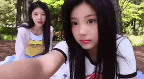 two girls are taking a selfie in a park and one of them is wearing a shirt that says safety first on it