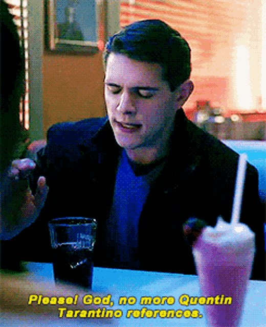 a man sitting at a table with a milkshake and a glass of soda and says please god no more quentin tarantino references