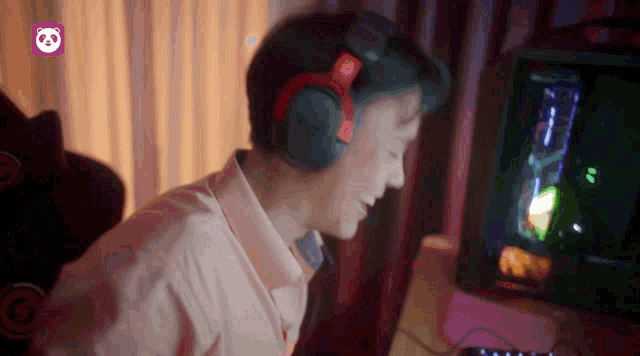 a person wearing headphones is playing a video game on a computer