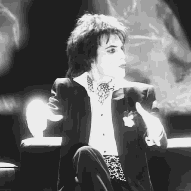 a black and white photo of a person in a suit