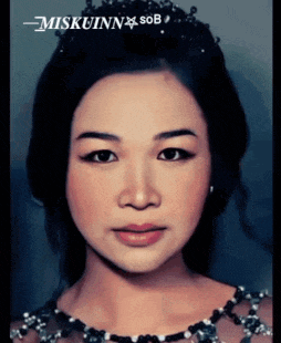 a close up of a woman 's face with miskuin sob on the bottom
