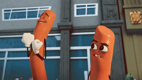 two sausages are standing next to each other in front of a window