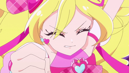a close up of a pink and yellow anime character with a heart on her ear