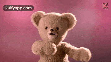 a teddy bear is standing in front of a pink background with the words kulfyapp.com above it .