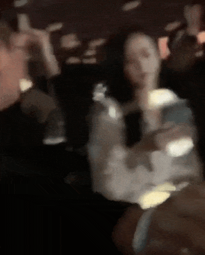 a blurry picture of a man and woman dancing in a club .