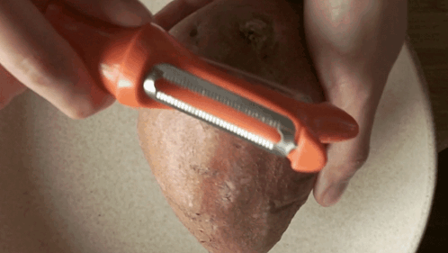Peeling The Sweet Potato Two Plaid Aprons GIF - Peeling The Sweet Potato Two Plaid Aprons Removing Skin GIFs