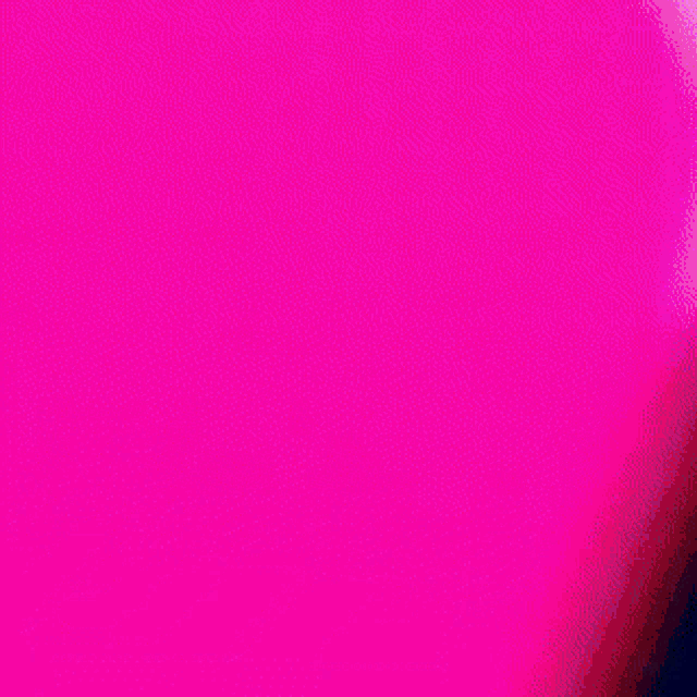 a close up of a green light on a black background
