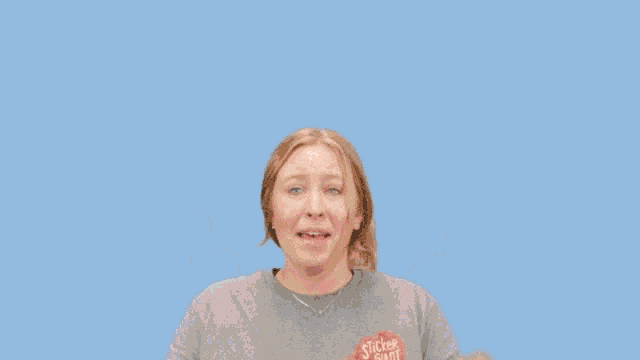 a woman wearing a shirt that says this is making a face
