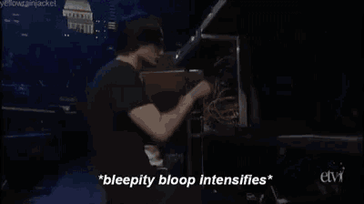 a man in a black shirt is playing a piano and says " bleepity bloop intensifies " .