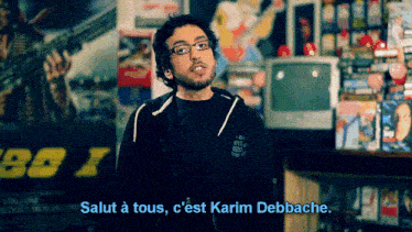 a man wearing glasses says salut a tous c'est karim debbache