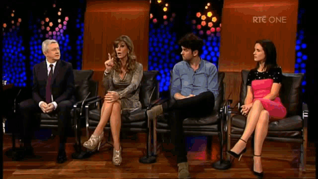 a group of people are sitting in chairs with the words " you are an odious little man " on the screen