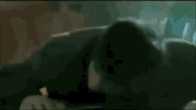a blurry picture of a naked man with a blue object in his pants