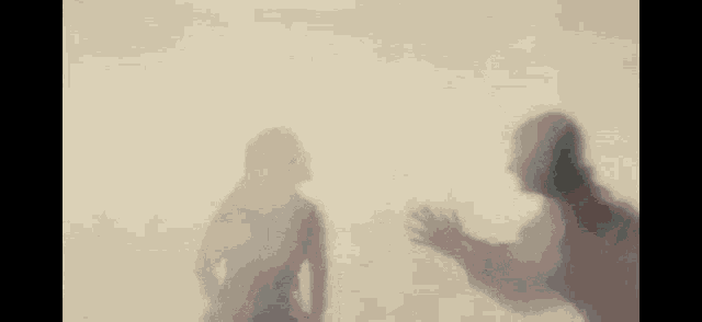 a man and a woman are standing next to each other and talking behind a veil .