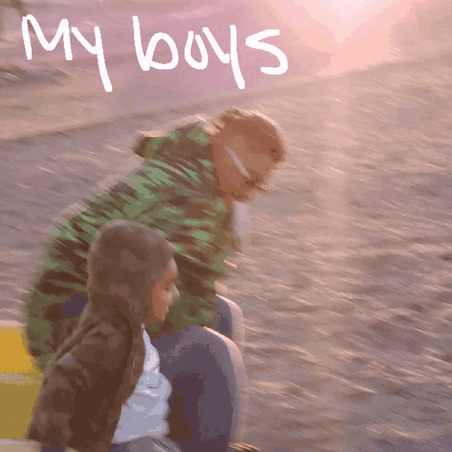 a blurry photo of a man and a child with the words my boys written on the bottom