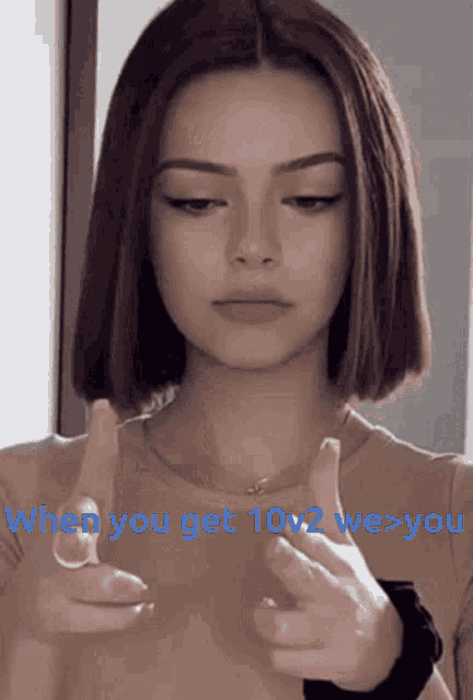 a woman pointing at the camera with the words " when you get 10v2 we > you " below her