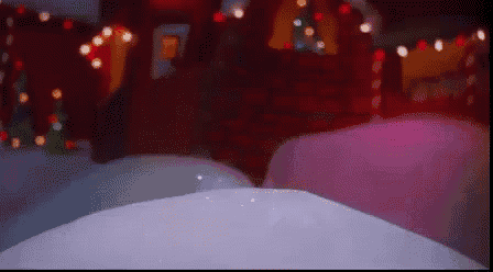a blurred image of a room with christmas lights and a christmas tree in the background