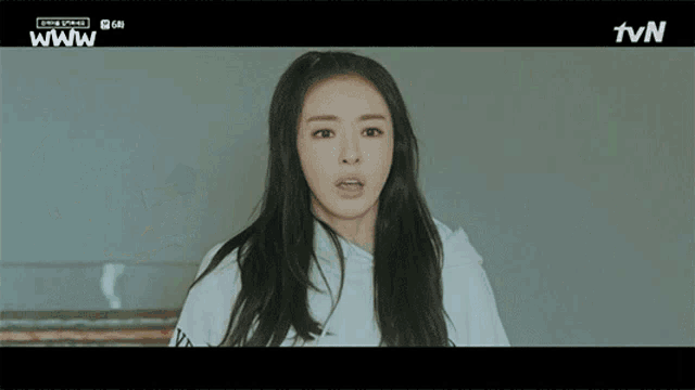 a woman in a white hoodie with the tvn logo on the bottom right