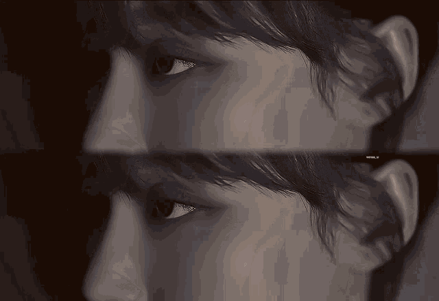 a black and white photo of a woman 's face with a watermark that says ' a ' on it