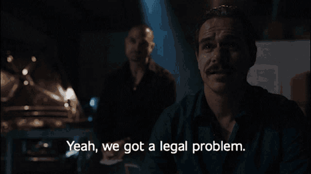 a man says " yeah we got a legal problem " in a dark room