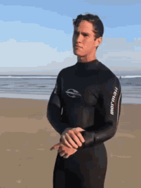 a man wearing a wetsuit with the word mormaii on it