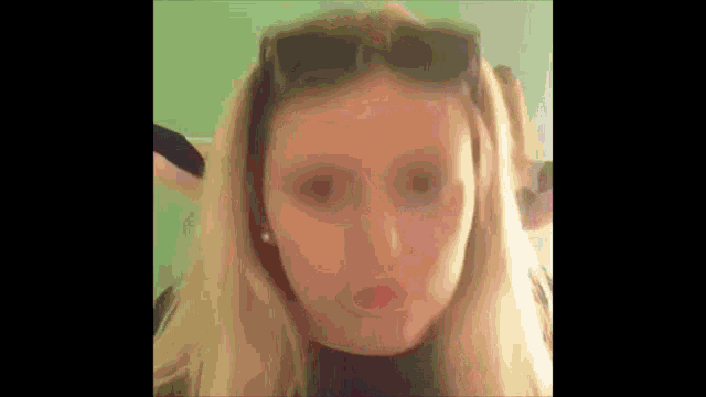 a close up of a woman 's face with sunglasses on