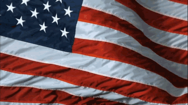 a close up of an american flag with white stars on it