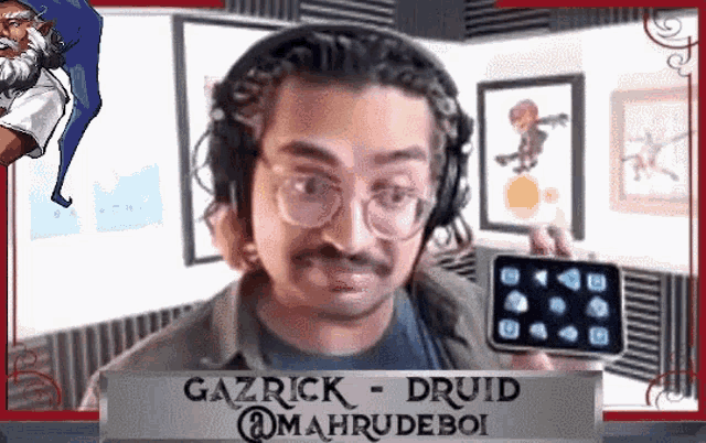 a man wearing headphones and glasses is holding a phone with gazrick druid @mahrudeboi on it