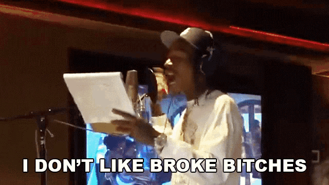 a man singing into a microphone with the words i do n't like broke bitches written below him