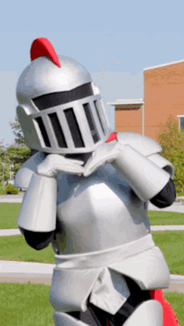 a mascot dressed as a knight with a red crest on his head