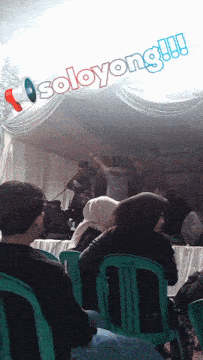 a group of people sitting under a tent with the words soloyong written on the ceiling