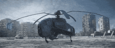 a helicopter is flying over a snowy city