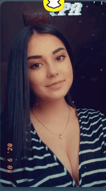 a woman in a striped shirt is taking a selfie with a snapchat filter on her face