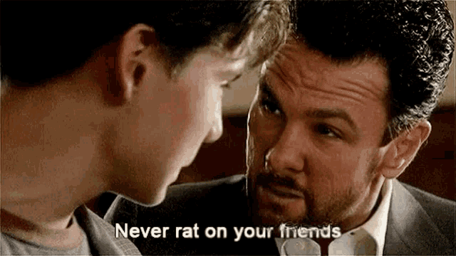 a man and a boy are talking to each other and the boy is telling the man not to rat on his friends .