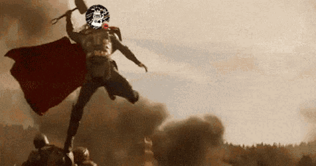 a man with a red cape is holding a hammer in his right hand