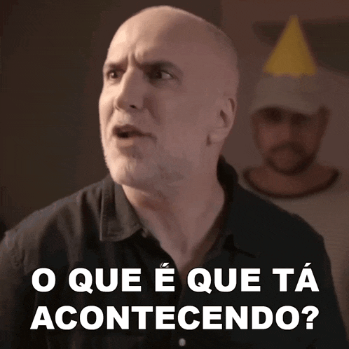 a bald man with a beard and a party hat says o que e que ta acontecendo