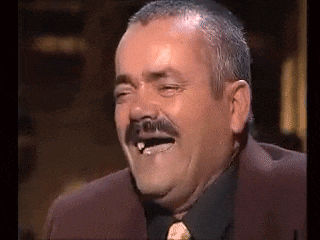 a man with a mustache is laughing with his eyes closed and his mouth open .