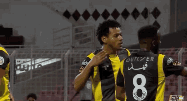 two soccer players one with the number 8 on their back