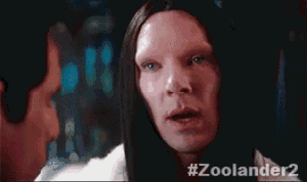 a man with long hair is talking to another man in a zoolander 2 movie .