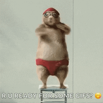 a hamster wearing red swim trunks and goggles is jumping in the air .