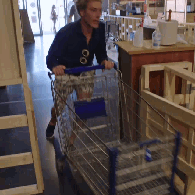 a man pushing a shopping cart in a store