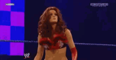 a woman is standing in a wrestling ring with a sky sports hd logo behind her