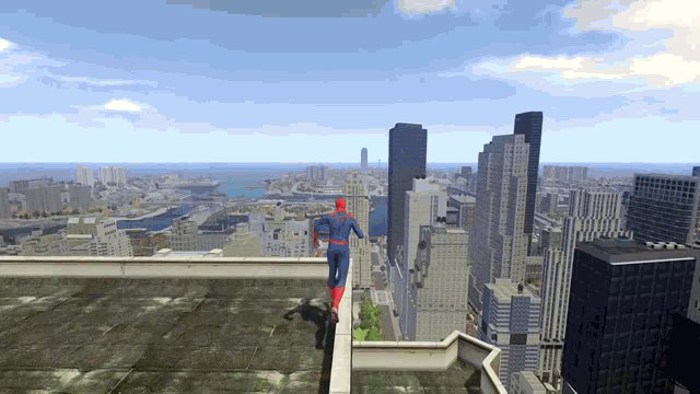 a person in a spiderman costume is standing on a rooftop overlooking a city