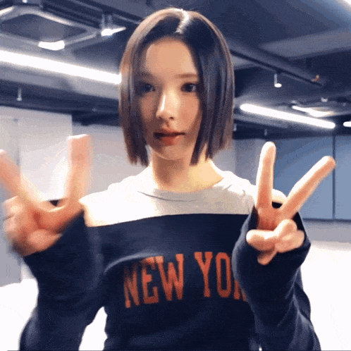 a woman wearing a sweater that says new york