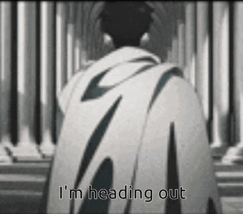 a man in a cape is standing in front of a wall with the words `` i 'm heading out '' .