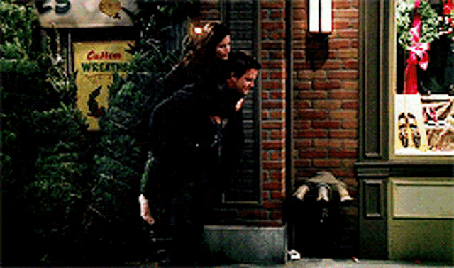 a man is giving a woman a piggyback ride in front of a sign that says cotton wreaths