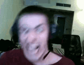 a blurry picture of a man wearing headphones and a choker