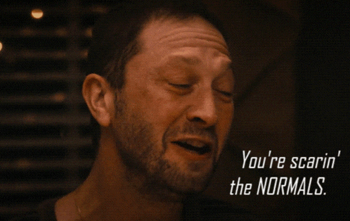 a close up of a man with the words you 're scarin ' the normals below him