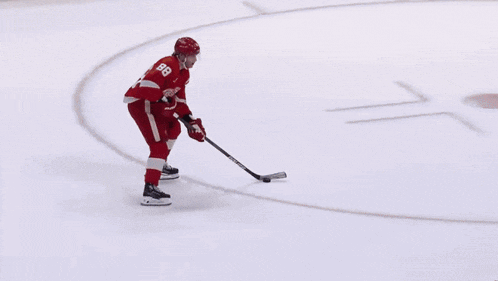 a hockey player wearing a red jersey with the number 8 on it