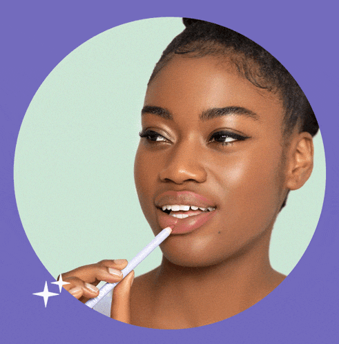 a woman is holding a purple lip pencil that says soul stick on it