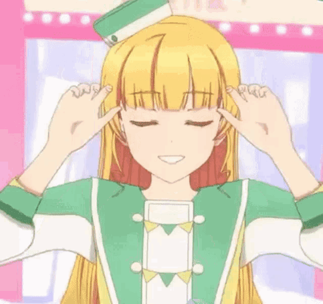 a girl with blonde hair and green eyes is making a surprised face with her hands .